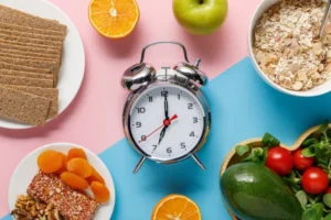Intermittent fasting concept showing a clock with healthy foods around it, illustrating eating windows and fasting periods.