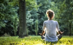 Person meditating to represent improved brain health and mental clarity benefits of intermittent fasting.