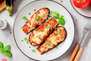 Slices of baked eggplant layered with marinara sauce and melted cheese