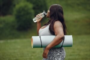 Woman drinking water to support weight loss