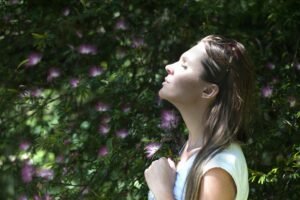 Person meditating outdoors, symbolizing relaxation and peace